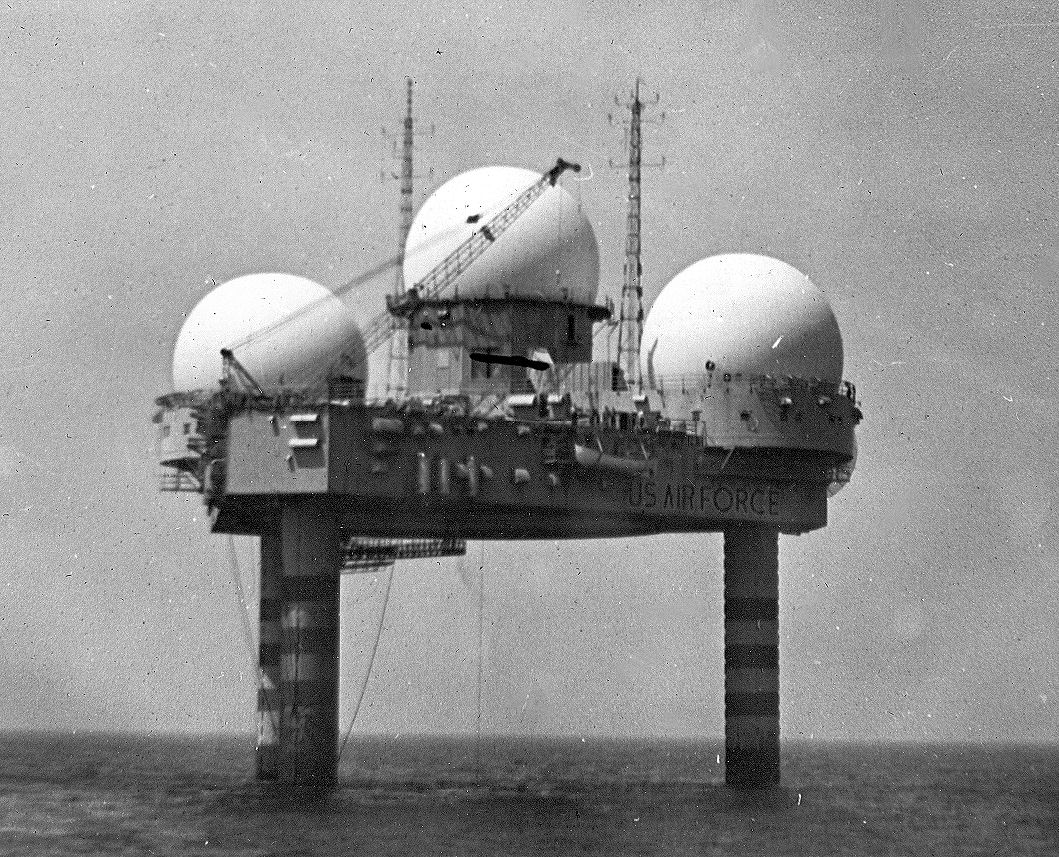 An offshore platform similar to an oil rig. Three RADAR domes are attached to it. "US Air Force" is painted on the side of the rig.