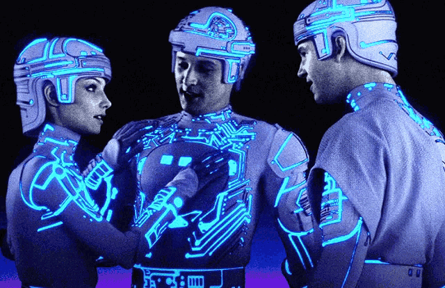 From the movie TRON. Yori, Tron, and Flynn in their white with blue outline costumes.